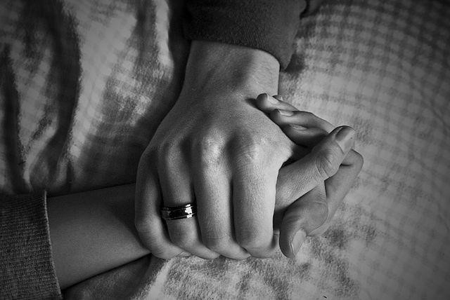 holding hands to comfort the patient
