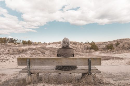 older man on bench contemplating life